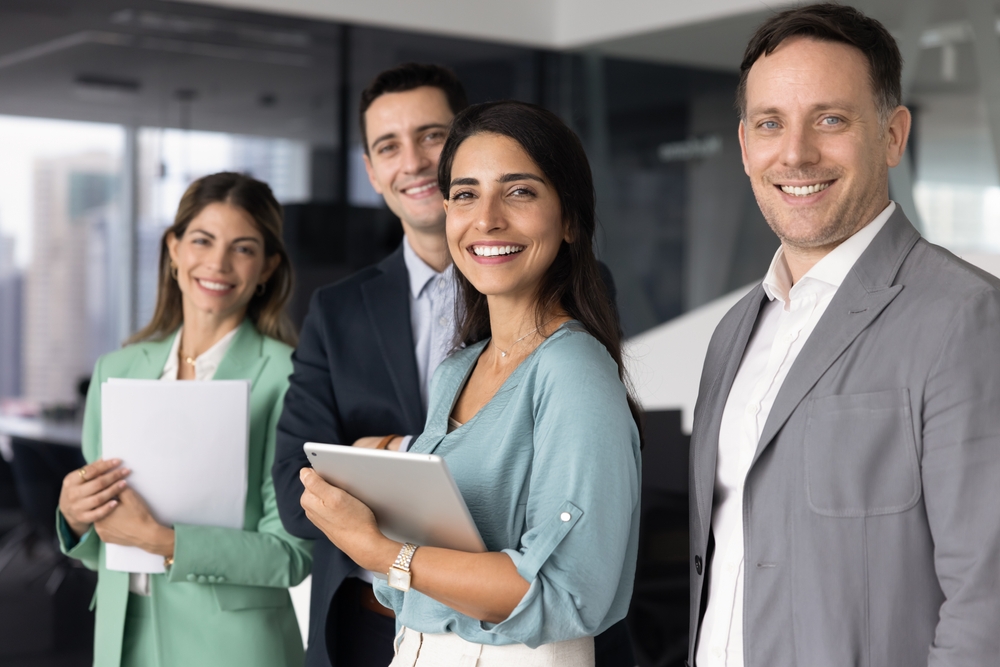 Confident,Diverse,Business,Team,Standing,Together,In,Modern,Office,,Look