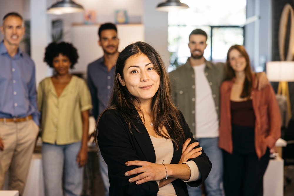 Confident,Female,Leader,With,Arms,Crossed,Standing,In,Front,Of
